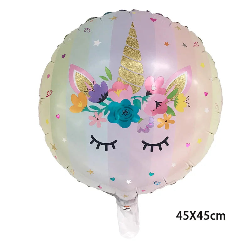 Aluminum foil balloon unicorn with sleeping face, gold horn and pastel striped background