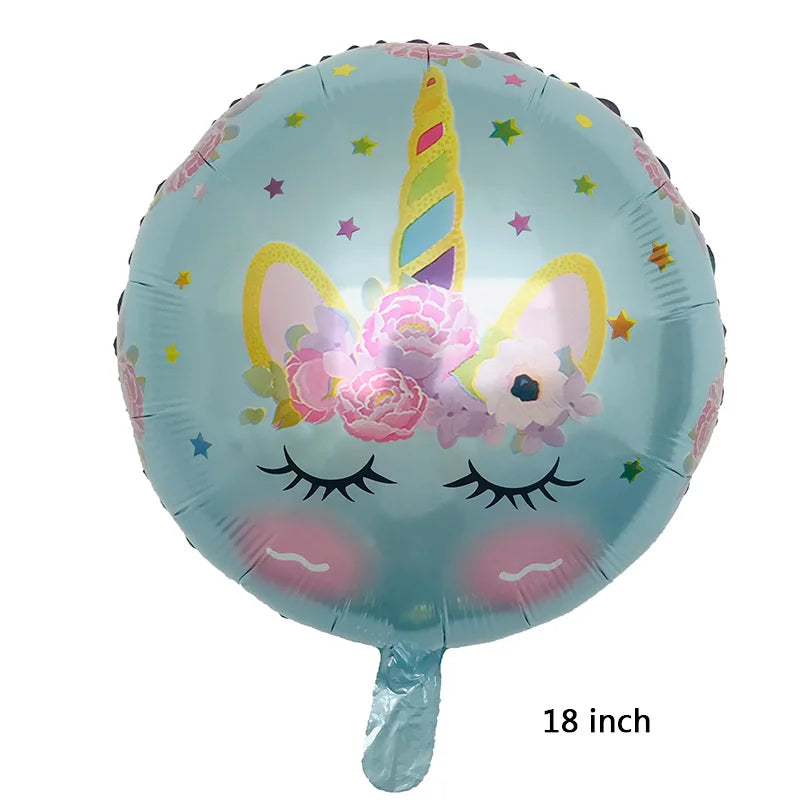 Inflated unicorn balloon floating above a birthday table