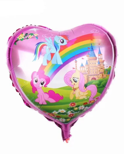 Foil unicorn balloon hanging on a wall at a birthday party