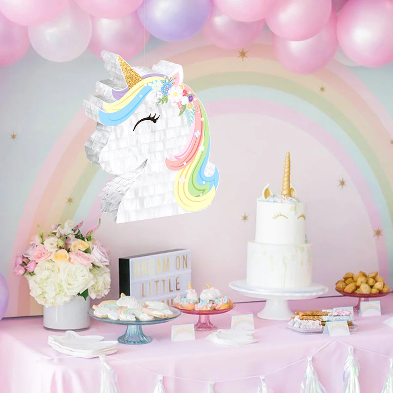 Gold glitter horn and white paper face of the unicorn pinata