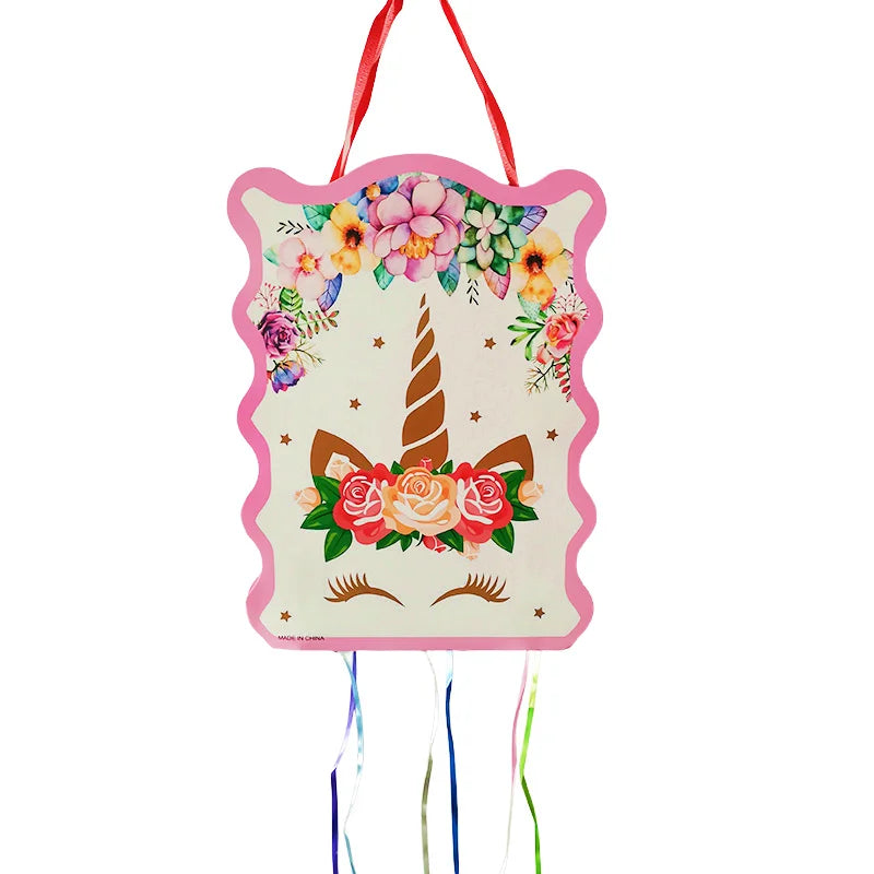 Pink unicorn pinata with gold horn, flower crown and colorful pull ribbons