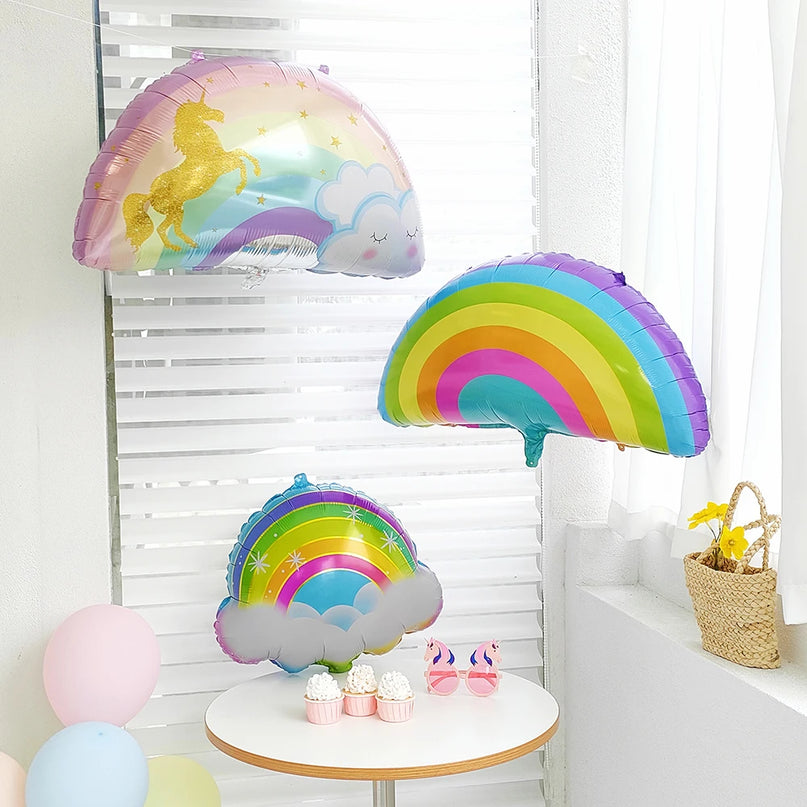Unicorn balloon with closed eyes and gold horn on a balloon stick