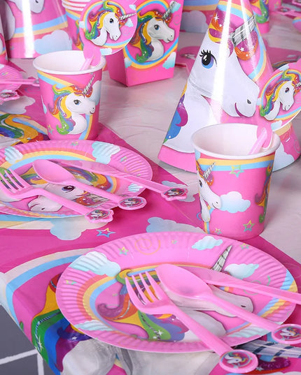 Pink unicorn birthday plate with cake and party snacks
