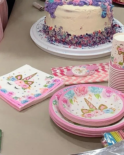 Close up of unicorn face on white paper party plate with pink flowers