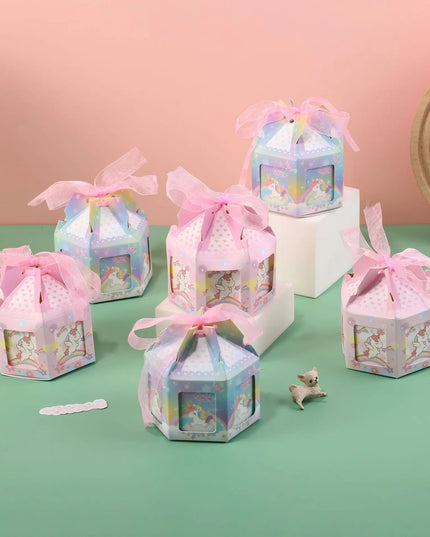 Unicorn favor box folded flat with pink sheer ribbon beside it