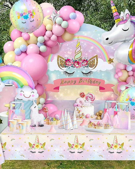 Unicorn foil balloon with rainbow detail next to the balloon garland