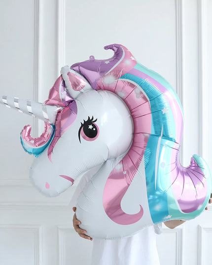 Close-up of the gold horn and pink flowers on the unicorn foil balloon