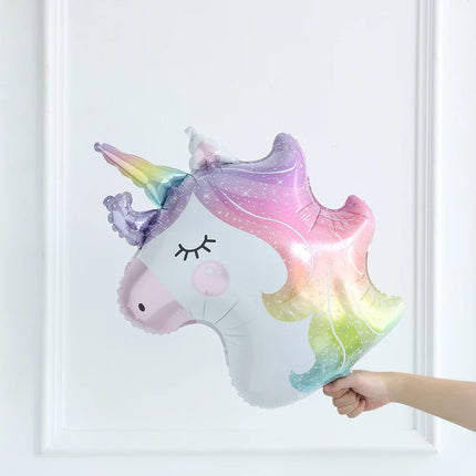 White unicorn shape foil balloon with pastel rainbow mane and pink cheeks