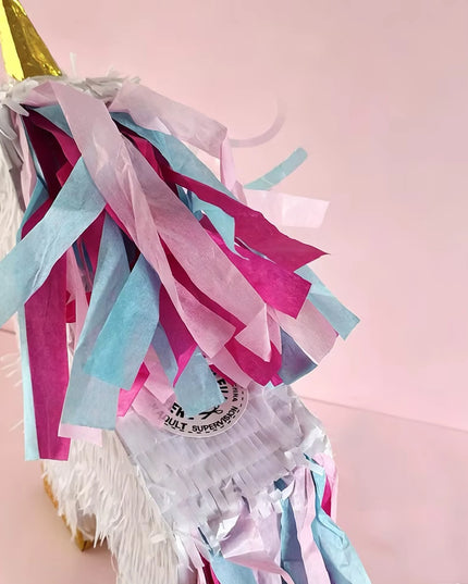 Golden hooves and turquoise tail detail on the white unicorn pinata