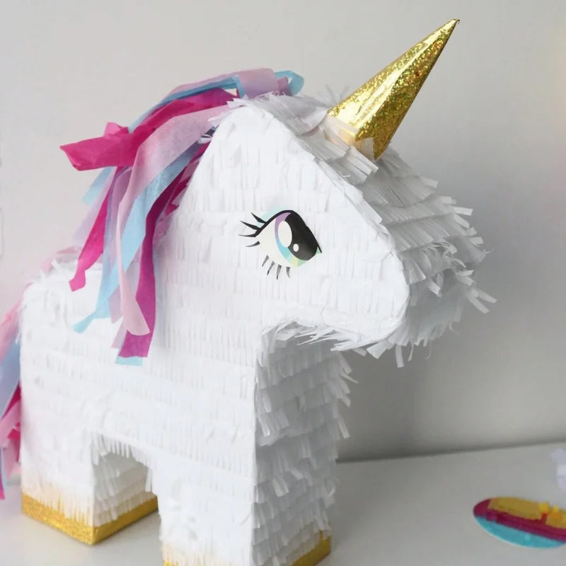 Unicorn pinata shown with blindfold and stick for party games