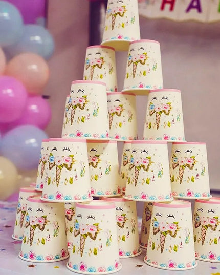 Side view of the round paper plate with pink rim and unicorn design
