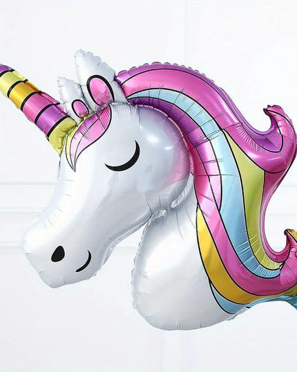 Full balloon arch setup framing a unicorn birthday backdrop