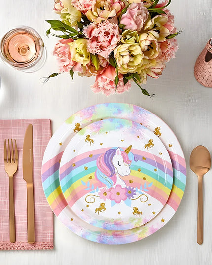 Rainbow unicorn paper plates set up for a birthday cake table