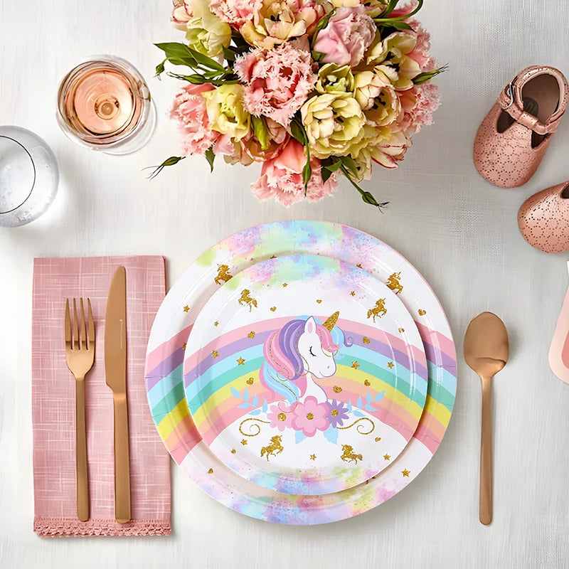 Rainbow unicorn paper plates set up for a birthday cake table