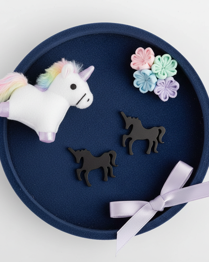 black unicorn earrings - flat-lay