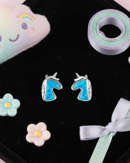 blue unicorn earrings - flat-lay