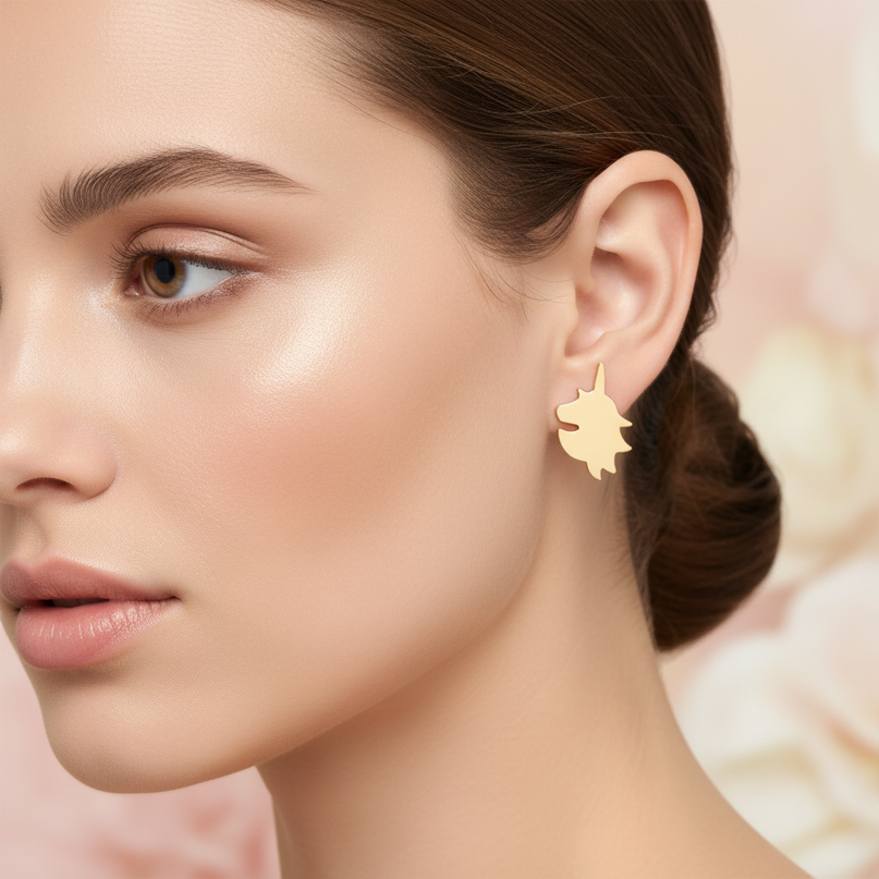 gold colored unicorn earrings - in-use