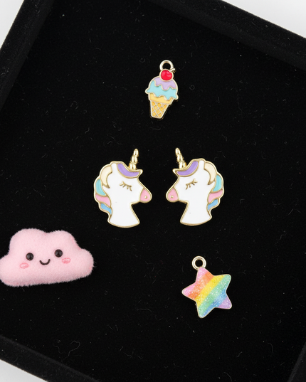 gold plated unicorn earrings - flat-lay