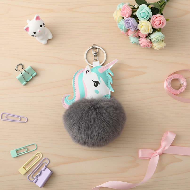 gray unicorn keychain - flat-lay