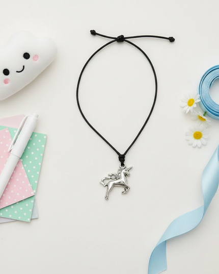 jumping unicorn necklace - flat-lay