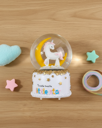 musical snow globe unicorn - flat-lay