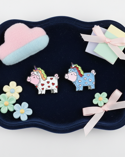 pig unicorn earrings - flat-lay
