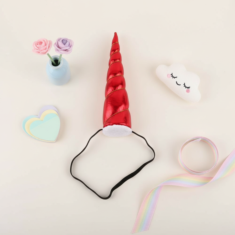 red elastic unicorn horn - flat-lay