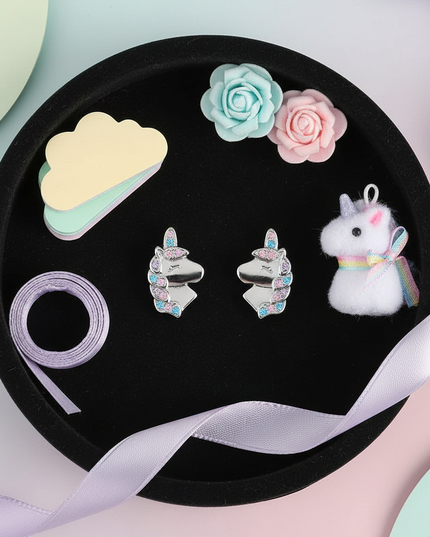 silver unicorn stud earrings - flat-lay