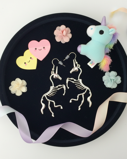 skeleton unicorn earrings - flat-lay