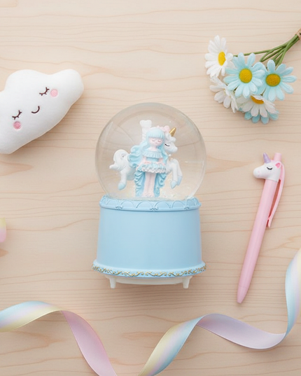 snow globe with unicorn - flat-lay