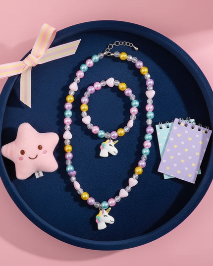 unicorn necklace little girl - flat-lay