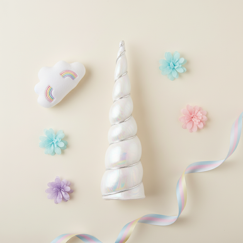white iridescent unicorn horn - flat-lay